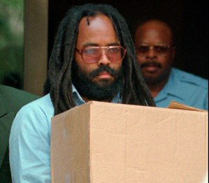 In this July 12, 1995 file photo, Mumia Abu-Jamal leaves Philadelphia's City Hall after a hearing. (AP Photo/Chris Gardner, File)