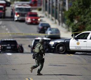 A San Diego police officer patrols a neighborhood in San Diego on Wednesday, Nov. 4, 2015.