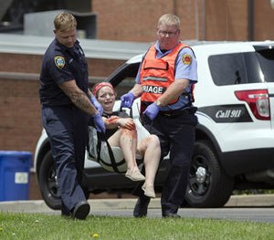 Emergency personnel carrying a volunteer with simulated injuries is carried during a training exercise for an active shooter at Hopewell Elementary School, Wednesday, May 25, 2016, in West Chester, Ohio.