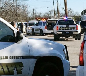 Law enforcement personnel from the Ellis County Sheriff's Office park outside a high school in Italy, Texas, following an active shooter incident at the school Monday morning, Jan. 22, 2018.