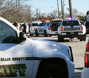 Law enforcement personnel from the Ellis County Sheriff's Office park outside a high school in Italy, Texas, following an active shooter incident at the school Monday morning, Jan. 22, 2018.
