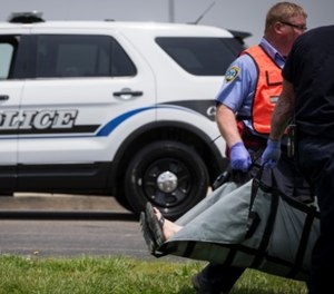 Emergency personnel carry a volunteer to a triage staging area during a training exercise for an active shooter with simulations at Hopewell Elementary School, Wednesday, May 25, 2016, in West Chester, Ohio.