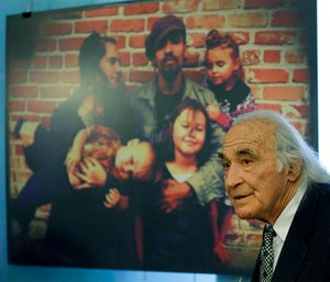 Attorney Tony Serra, representing Derick Almena, speaks during a media conference beside a photograph of the Almena family.