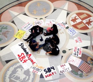 Students gather in the Rotunda at the Texas Capitol to oppose SB4, an anti-