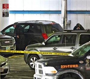 Members of the bomb squad check out a parked SUV at port Columbus Airport on Wednesday, Jan. 7, 2015.