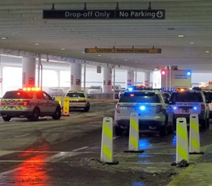 Emergency vehicles converge at the ticketing level at Port Columbus International Airport after officials say an airport police officer shot and killed a man after a confrontation, Wednesday, Jan. 7, 2015, in Columbus, Ohio.