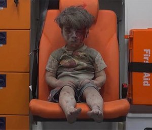 A child sits in an ambulance after being pulled out or a building hit by an airstirke, in Aleppo, Syria, Wednesday, Aug. 17, 2016.