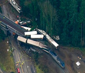 The train derailed about 40 miles (64 kilometers) south of Seattle before 8 a.m., spilling at least one train car on to busy Interstate 5.