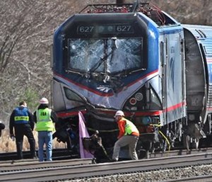 Amtrak investigators inspect the deadly train crash in Chester, Pa. The Amtrak train struck a piece of construction equipment just south of Philadelphia causing a derailment. (Michael Bryant/The Philadelphia Inquirer via AP)