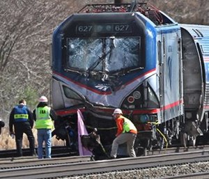 Amtrak investigators inspect the deadly train crash in Chester, Pa. The Amtrak train struck a piece of construction equipment just south of Philadelphia causing a derailment. (Michael Bryant/The Philadelphia Inquirer via AP) 