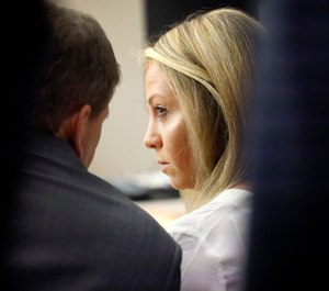 Former Dallas police officer Amber Guyger listens to her attorney Toby Shook during her trial at the Frank Crowley Courts Building in Dallas, Saturday, Sept. 28, 2019. (Tom Fox/The Dallas Morning News via AP, Pool)