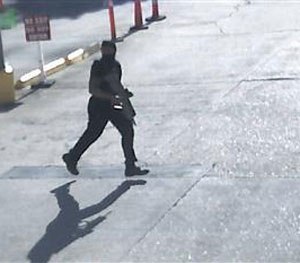 This Sunday, July 17, 2016, frame from security video provided by the Louisiana State Police shows Gavin Eugene Long carrying a weapon in Baton Rouge, La. (AP Image)