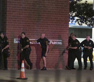 Dallas police respond after shots were fired during a protest over recent fatal shootings by police in Louisiana and Minnesota, Thursday, July 7, 2016, in Dallas. (Maria R. Olivas/The Dallas Morning News via AP)