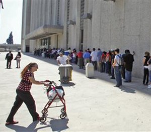 In this March 18, 2010 file photo, people line up outside the Metropolitan Courthouse in downtown Los Angeles. (AP Image)