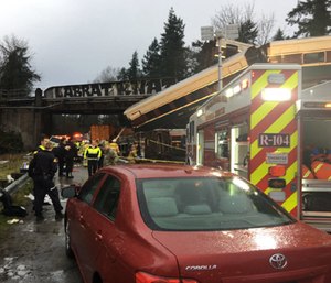 An Amtrak train derailed about 40 miles south of Seattle Monday, spilling at least one train car on to busy Interstate 5.
