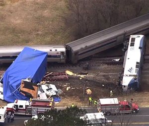In this frame grab from video provided by WTVD-11, authorities respond to a collision between an Amtrak passenger train and a truck, Monday, March 9, 2015, in Halifax County, N.C. According to Halifax County Sheriff Wes Tripp, none of the injuries appeared to be life-threatening. (AP Photo/WTVD-11)
