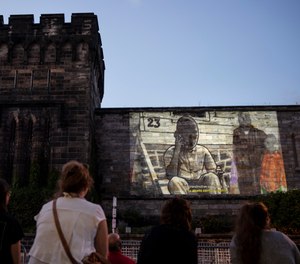 In this Tuesday, Sept. 3, 2019 photo, people view incarcerated filmmaker Robert's animated short titled
