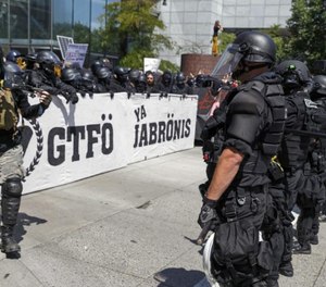 Portland police keep Patriot Prayer affiliates separate from antifa protesters during a rally in Portland, Ore., Saturday, Aug. 4, 2018.