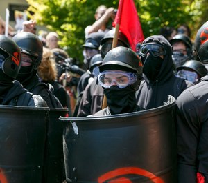 Counter-protesters prepare to clash with Patriot Prayer protesters during a rally in Portland, Ore., Saturday, Aug. 4, 2018. (AP Photo/John Rudoff)