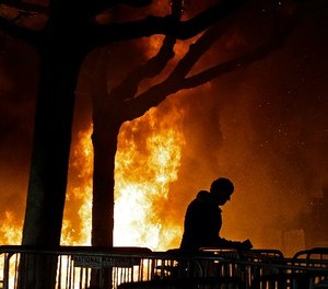 A bonfire set by demonstrators protesting a scheduled speaking appearance by Milo Yiannopoulos, Feb. 1, 2017, in Berkeley, Calif.