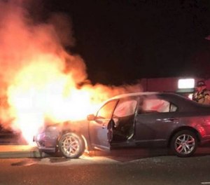 Officer Josh Page removed the driver from the burning car, suffering minor injuries in the process.