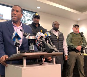 Forrest City, Ark., Mayor Cedric Williams, left, holds a news conference after two police officers were wounded and a gunman was killed in an exchange of gunfire at a Walmart store in eastern Arkansas Monday morning Feb. 10, 2020. (AP Photo/Adrian Sainz)