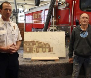 Artist Eric Waller presented Duluth Fire Department staff with a relief depicting the fire station carved into a slab of white Italian Carrara marble.