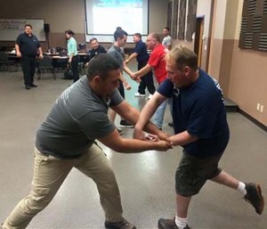 Firefighter Eric Karcher escapes an arm grab from EMT Nick Egloff.