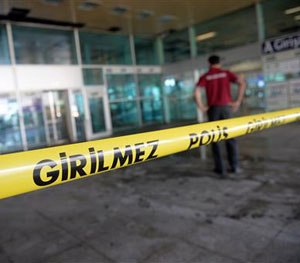 A worker inspects the damages at the entrance of Istanbul's Ataturk airport, Wednessday, June 29, 2016.