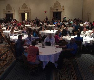 Attendees discussing Taigman's questions in small groups.