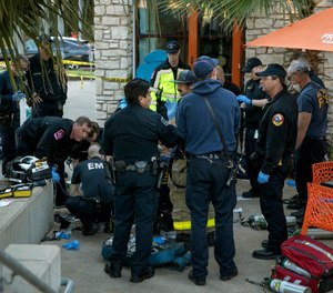 Police and paramedics respond to a stabbing at an Austin, Texas shopping plaza. (Photo/AP)