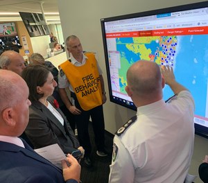 New South Wales Premier Gladys Berejiklian (in black, third from left) declared a state of emergency Monday due to dangerous bushfires raging across the Australian state since last week.