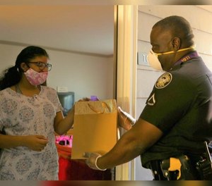Atlanta police investigator Keith Backmon, right, used his hazard pay to purchase Amazon tablets for five children unable to complete their schoolwork due to lack of resources.