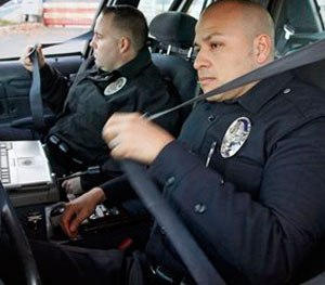 Pictured are L.A. officers Adrian Garcia, right, and Christopher Ballerini. Studies show leaning forward to type, and exiting your vehicle by pivoting on one knee causes joint and back pain.