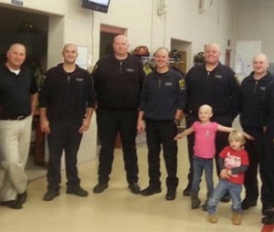 Michigan medics and firefighters had their heads shaved to support a 4-year-old girl's battle with leukemia.