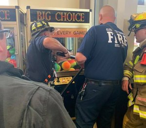 Gloucester firefighters rescued a small child from a claw machine filled with bouncy balls on Wednesday.