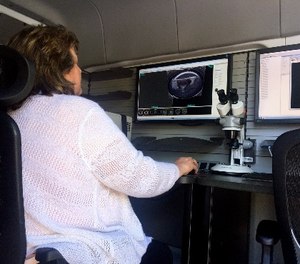A woman works from a U.S. Bureau of Alcohol, Tobacco, Firearms and Explosives mobile ballistics trailer on Tuesday, May 2, 2017, in Baltimore. (AP Photo/Juliet Linderman)