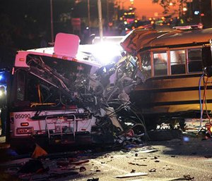 Fire department and rescue officials are at the scene of an early morning fatal collision between a school bus and a commuter bus Tuesday, Nov. 1, 2016, in Baltimore. (Jeffrey F. Bill/Baltimore Sun via AP)