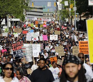 Protesters march through Baltimore on Saturday, May 2, 2015, the day after charges were announced against the police officers involved in Freddie Gray's death. (AP Image)