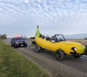 A Michigan State Trooper pulled Steve Braithwaite and his banana car over. The trooper has received viral acclaim for giving Braithwaite a $20 bill. (Photo/MSP)