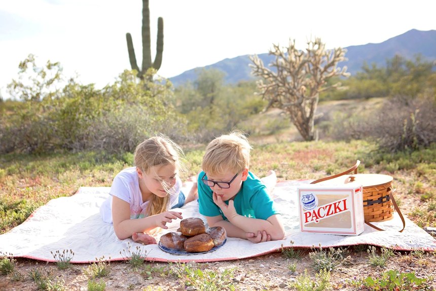 Rachel Barnes, 10, and brother Nathan, 8, in Arizona eat donuts shipped from Cops & Doughnuts of Clare, Michigan.