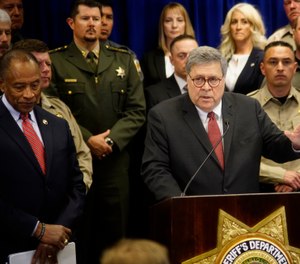 U.S. Attorney General William Barr, center, with other federal officials, announces that nearly 330 fugitives suspected of violent crimes have been arrested as part of a crime-fighting initiative in New Mexico. (Photo/AP)