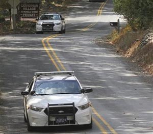 Three Pennsylvania State Police cars patrol along Snow Hill Road in Price Township, Pa, Tuesday, Sept. 30, 2014.