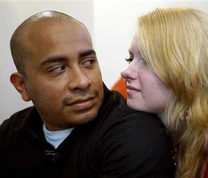 Dallas Police Department Officer Jorge Barrientos, left, is pictured recovering at his home with his girlfriend, Bethany Knutson, Sunday, July 10, 2016, in Dallas.