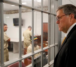 Attorney General William Barr watches as inmates work in a computer class during a tour of a federal prison Monday, July 8, 2019, in Edgefield, S.C.