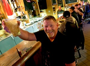 Marvin Radtke toasts the opening of the Friends and Neighbors bar following the Wisconsin Supreme Court's decision to strike down Gov. Tony Evers' safer-at-home order amid the coronavirus pandemic, Wednesday, May 13, 2020, in Appleton, Wis. Image: William Glasheen/The Post-Crescent via AP