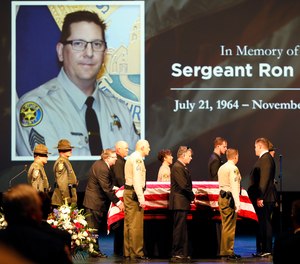 The flag draped casket of Ventura County Sheriff Sgt. Ron Helus arrives on stage for a memorial service for Sgt. Helus at Calvary Community Church in Westlake Village, Calif., Thursday, Nov. 15, 2018.