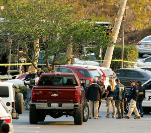 FBI investigators join law enforcement as they work near the scene of Wednesday's shooting in Thousand Oaks, Calif., Friday, Nov. 9, 2018.