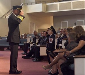 Chief Marc Bashoor salutes the son of a Prince George’s County, Maryland, firefighter during the firefighter’s funeral.