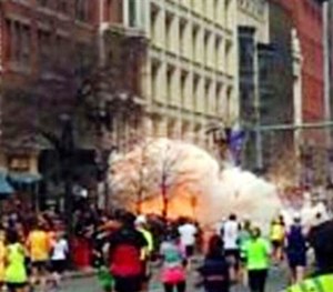 In this image from video provided by WBZ TV, a bomb explodes near the finish line of the Boston Marathon in Boston on Monday, April 15, 2013.